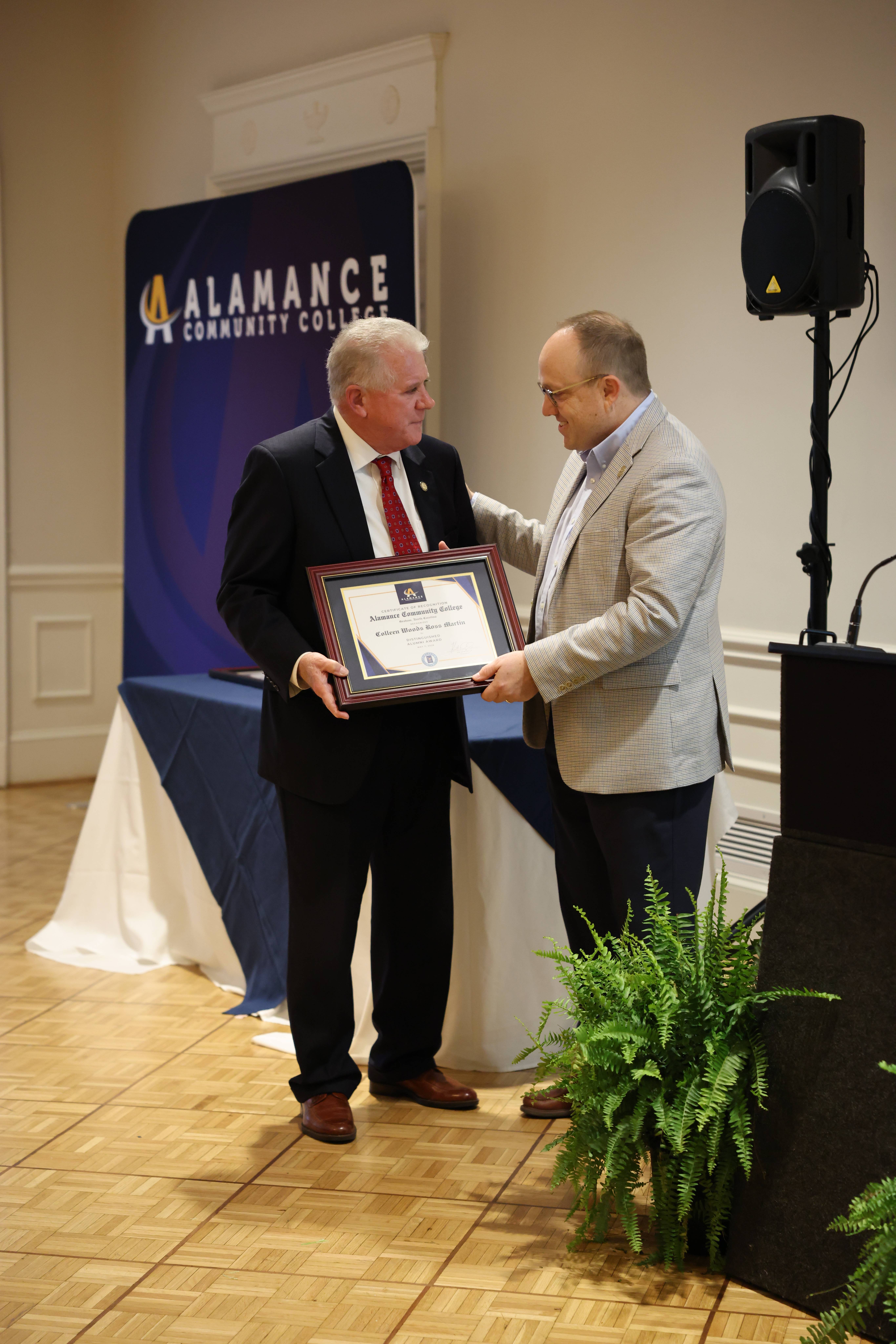 Dr. Ken Ingle presents the posthumous Distinguished Alumni Award in honor of the late Colleen Woods Ross Martin 