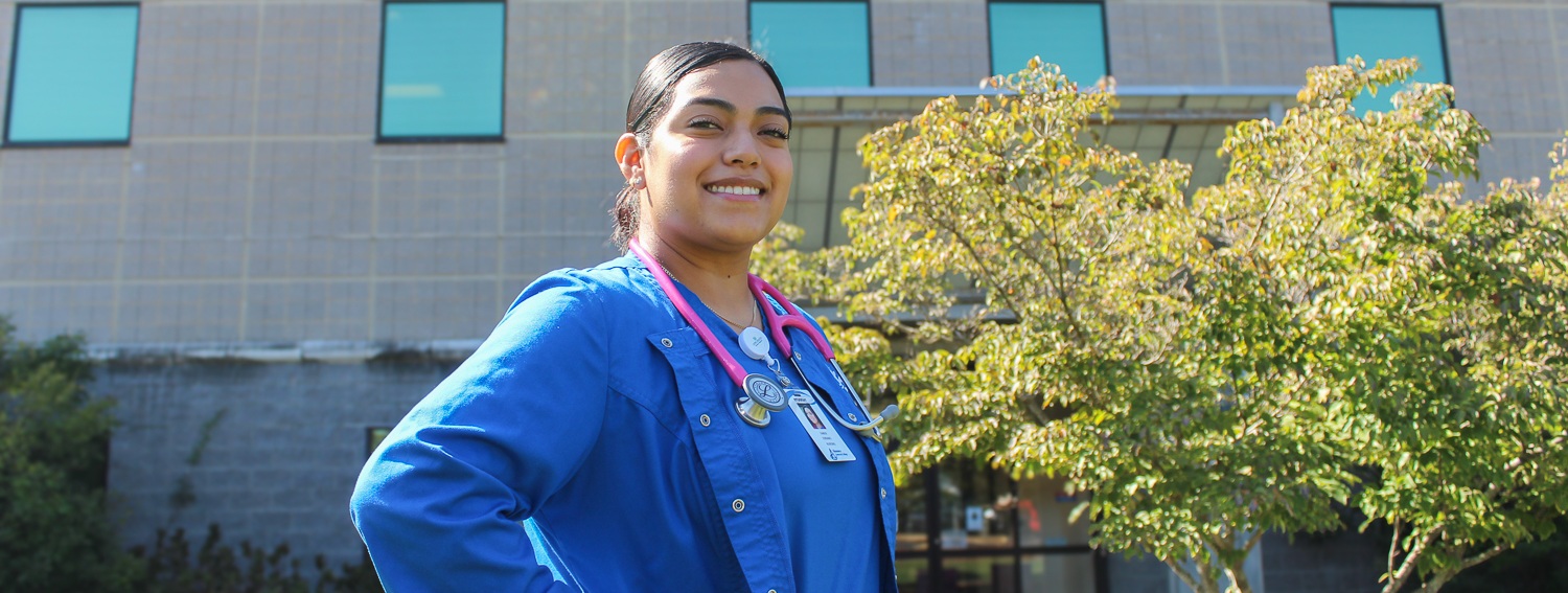 acc nursing student standing in from of the powell building.