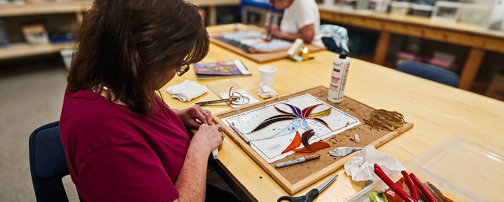 stained glass student looking at glass